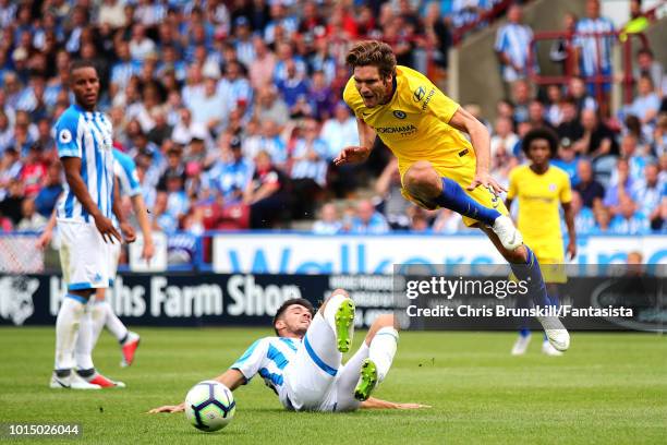 Christopher Schindler of Huddersfield Town fouls Marcos Alonso of Chelsea and a penalty is awarded during the Premier League match between...