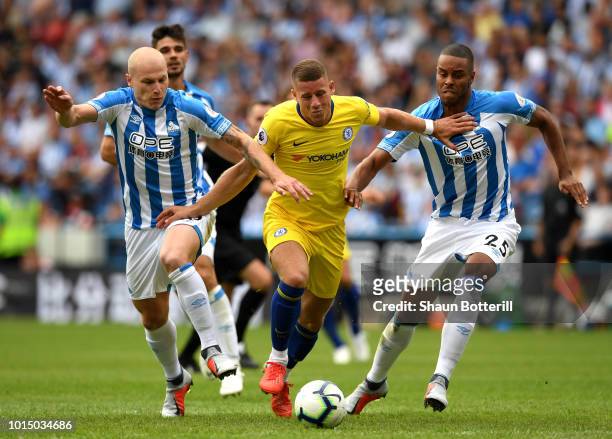 Ross Barkley of Chelsea is challenged by Aaron Mooy of Huddersfield Town and Mathias Zanka Jorgensen of Huddersfield Town during the Premier League...