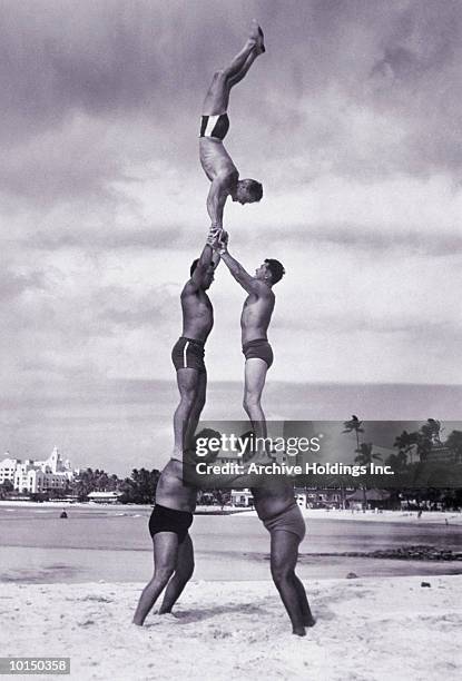 men and girl perform acrobatics on beach - balancing act fotografías e imágenes de stock