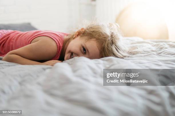 little girl jumping and laughing - movement makers stock pictures, royalty-free photos & images