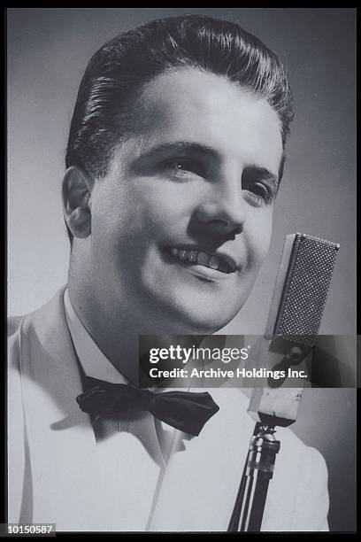 man in white tuxedo behind microphone - old fashioned microphone stock pictures, royalty-free photos & images