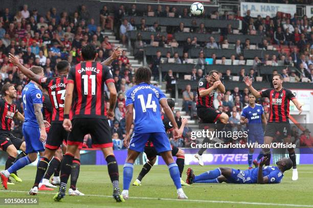 Ryan Fraser of Bournemouth holds his head after being hit by the foot of Sol Bamba of Cardiff as he attempted an overhead kick during the Premier...