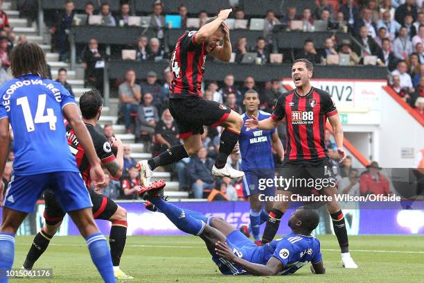 Ryan Fraser of Bournemouth holds his head after being hit by the foot of Sol Bamba of Cardiff as he attempted an overhead kick during the Premier...