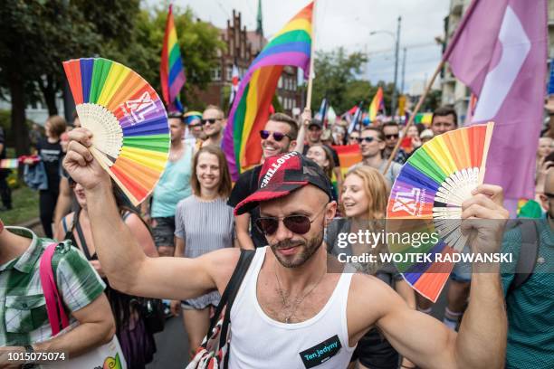 Participants of a gay pride parade walk through the streets of Poznan, August 11, 2018.