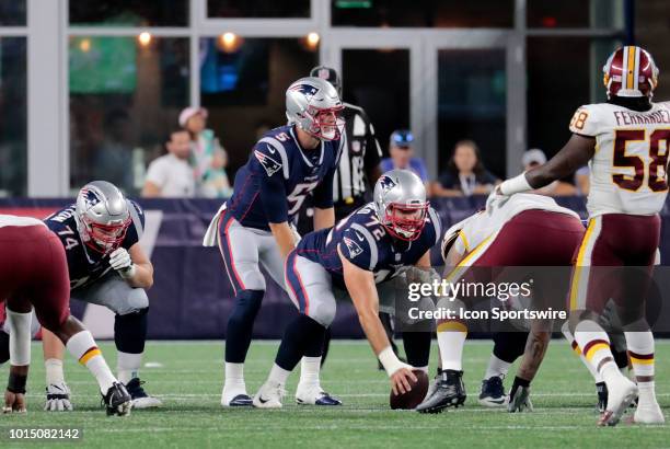 New England Patriots quarterback Danny Etling calls signals over New England Patriots offensive lineman Luke Bowanko during a preseason NFL game...