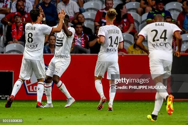 Rennes' French midfielder Clement Grenier is congratuled by his teammate after scoring a goal during the French L1 football match between Lille and...