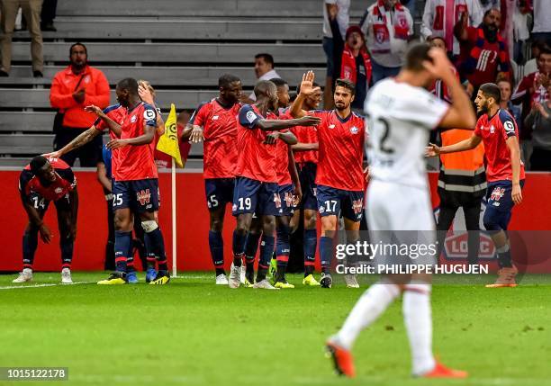 Lille's French midefielder Jonathan Bamba celebrates with teammates after scoring a gola during the French L1 football match between Lille and Rennes...