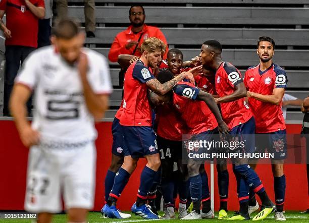 Lille's French midefielder Jonathan Bamba celebrates with teammates after scoring a gola during the French L1 football match between Lille and Rennes...