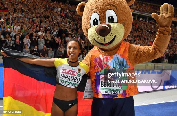 Germany's Malaika Mihambo celebrates with mascot Berlino and with her national flag after winning the women's Long Jump final during the European...