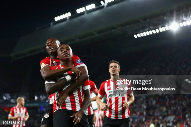 Steven Bergwijn of PSV celebrates scoring his teams second goal of the game with team mates Nick Viergever and Denzel Dumfries during the Eredivisie...