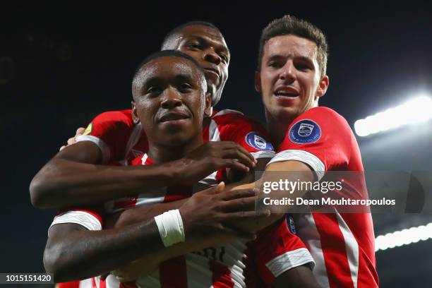 Steven Bergwijn of PSV celebrates scoring his teams second goal of the game with team mates Nick Viergever and Denzel Dumfries during the Eredivisie...