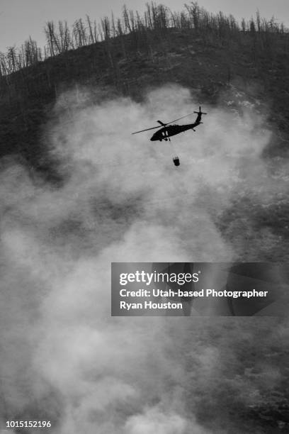 helicopter flies into forest fire smoke - utah wildfire stock pictures, royalty-free photos & images