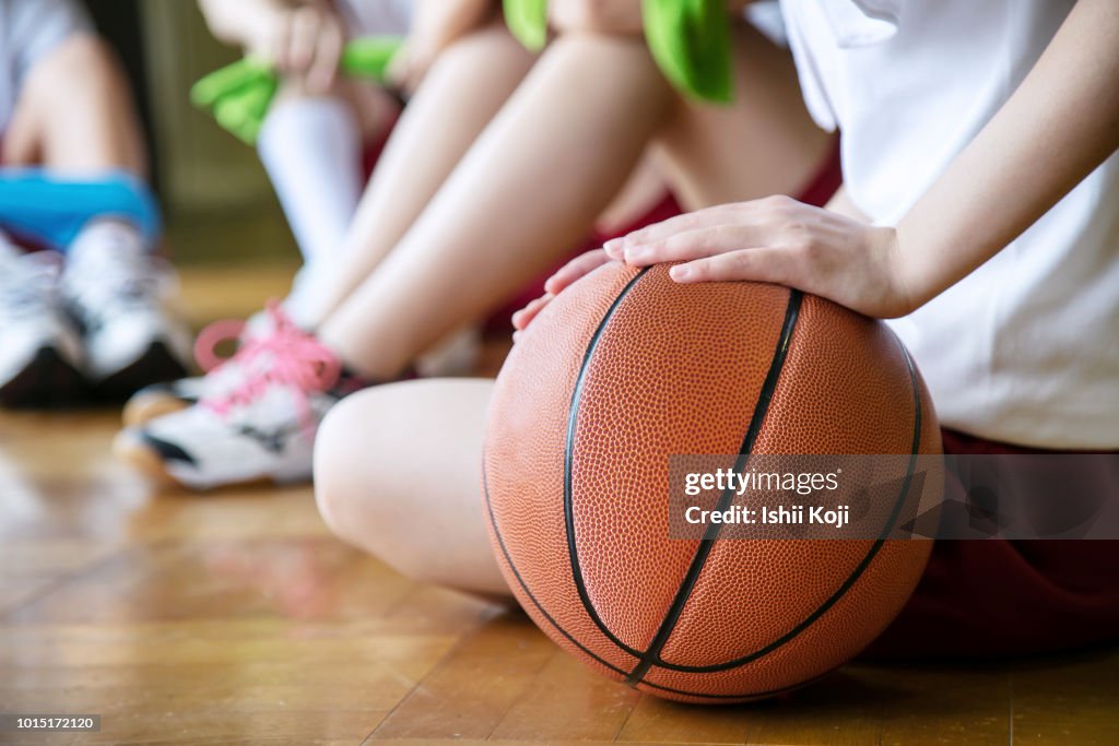 Group of jr. high students making exercise in gymnastic hall
