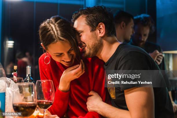 couple drinking wine at party in apartment - flirten stock-fotos und bilder