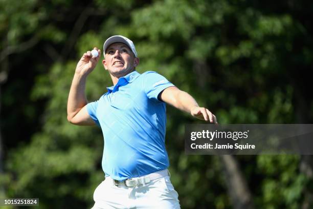 Matt Wallace of England throws a ball into the crowd on the 14th hole during the third round of the 2018 PGA Championship at Bellerive Country Club...