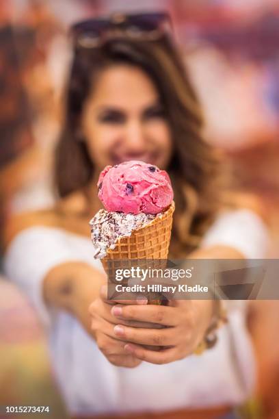 brunette woman holding ice cream - ice cream sundae stockfoto's en -beelden