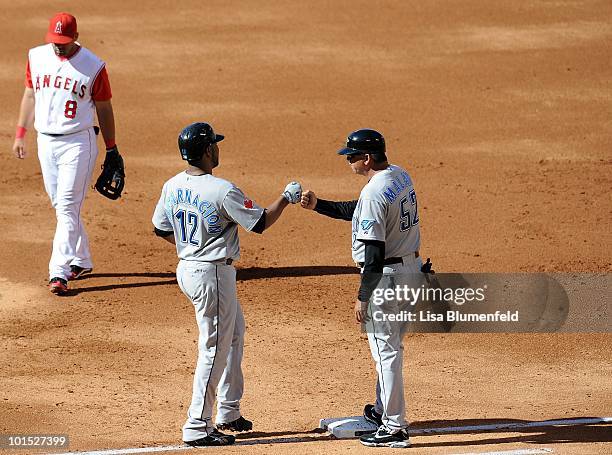 Edwin Encarnacion of the Toronto Blue Jays celebrates after a walk in the second inning against the Los Angeles Angels of Anaheim at Angel Stadium of...