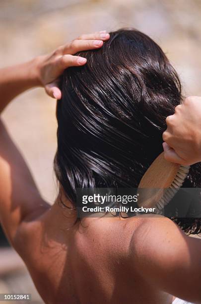woman brushing wet hair, close-up, rear view - hair imagens e fotografias de stock