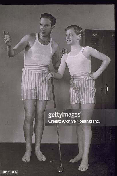 man and boy wearing boxer shorts, 1940 - men underware model stock pictures, royalty-free photos & images
