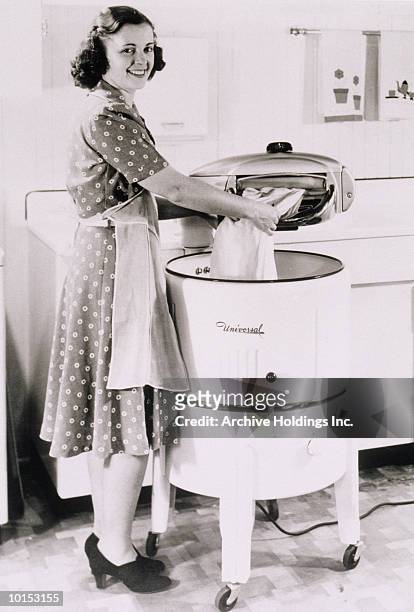 housewife doing laundry - hausfrau stock-fotos und bilder