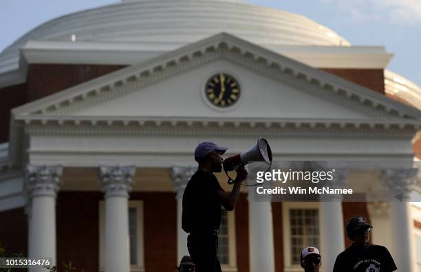Protesters with the group Students Act Against White Supremacy speak on the campus of the University of Virginia during an event marking the one year...