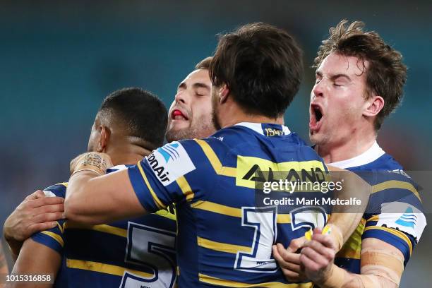 Eels players celebrate a tackle by George Jennings of the Eels during the round 22 NRL match between the Parramatta Eels and the St George Illawarra...