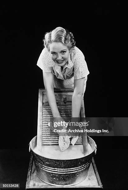woman cleaning clothes with washboard - washboard laundry stock pictures, royalty-free photos & images