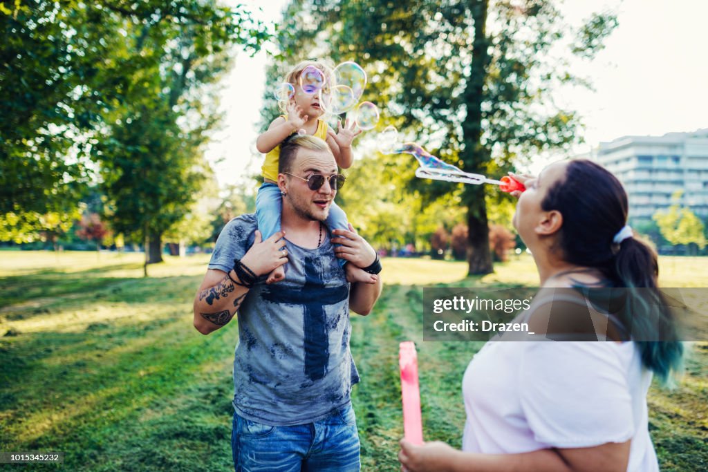 Mom and dad with three year old son in park