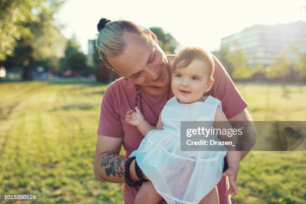 modern father holding his cheerful baby girl - gothic style stock pictures, royalty-free photos & images