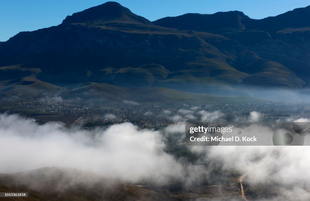 Village of Greyton nestled at the base of the Riviersonderend mountains, clearing mist, Overberg, Western Cape, South Africa
