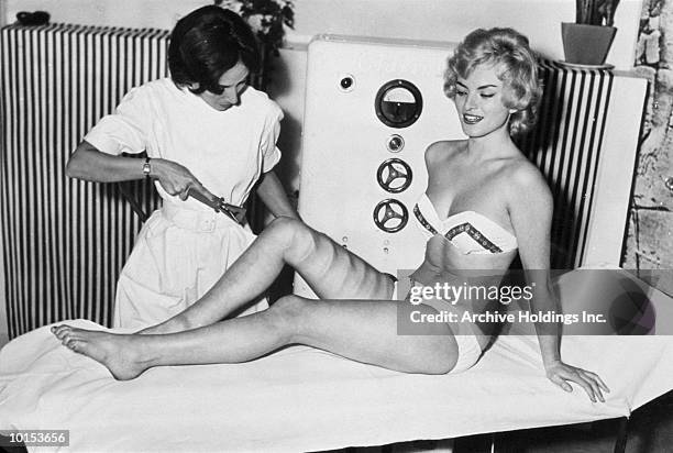 woman having fat blown off of leg - doctor humor stock pictures, royalty-free photos & images