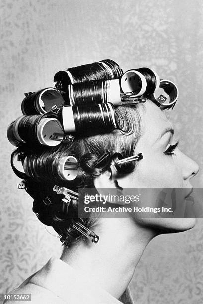 young woman wearing curlers, profile, 1960's (b&w) - hair curlers stockfoto's en -beelden