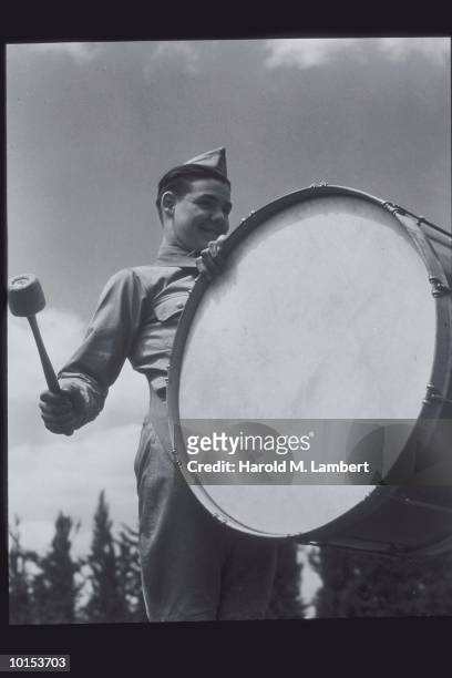 BOY SCOUT WITH LARGE DRUM AND MALLET, 1950