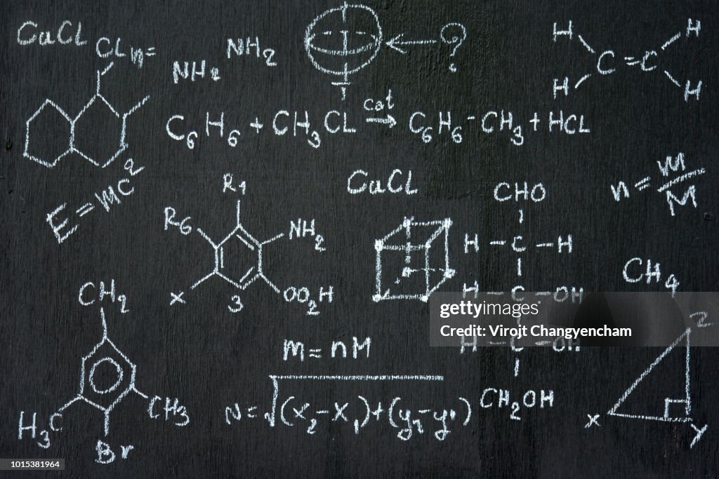 Chalkboard inscribed with scientific formulas and calculations in physics and mathematics. Vector illustration