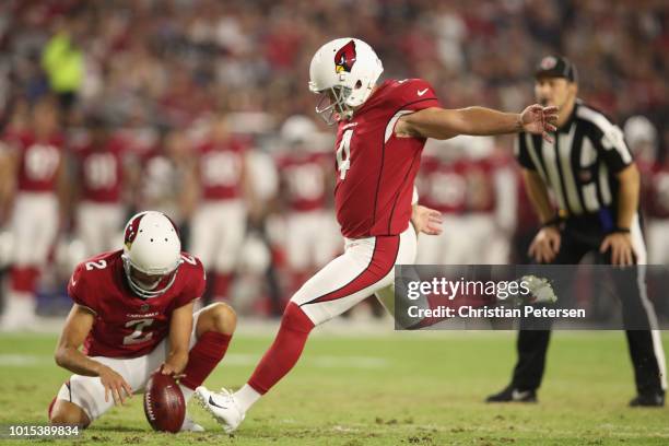 Kicker Phil Dawson of the Arizona Cardinals kicks a extra point held by punter Andy Lee during the preseason NFL game against the Los Angeles...