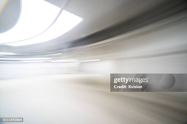 under ground parking lot in motion blur - white color car stock pictures, royalty-free photos & images