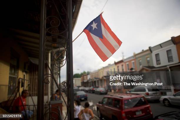 July 8, 2018: A Puerto Rican flag is hung on a row house in the historically Puerto Rican neighborhood, Hunting Park, in North Philadelphia, in...
