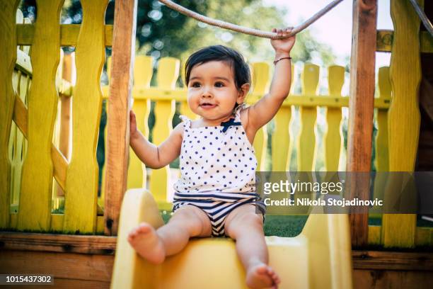 the baby is playing outside - baby girls stock pictures, royalty-free photos & images