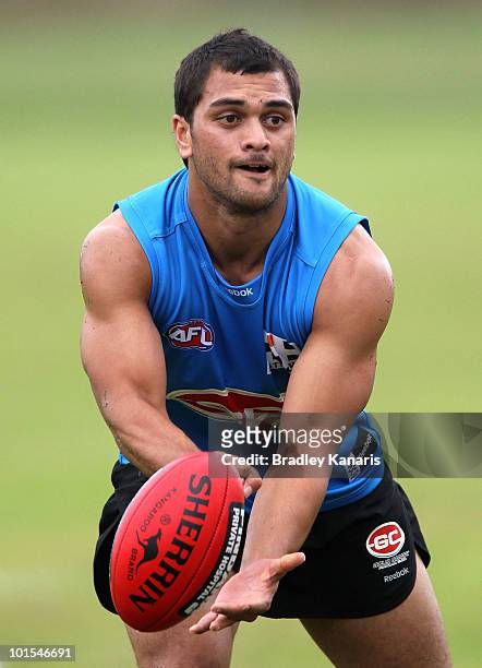 Karmichael Hunt of the Gold Coast Football Club hand passes during a Gold Coast Football Club training session on June 2, 2010 in Gold Coast,...