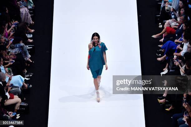Model presents a creation by Malaysian designer Carven Ong during the 2018 Kuala Lumpur Fashion week on August 12, 2018.