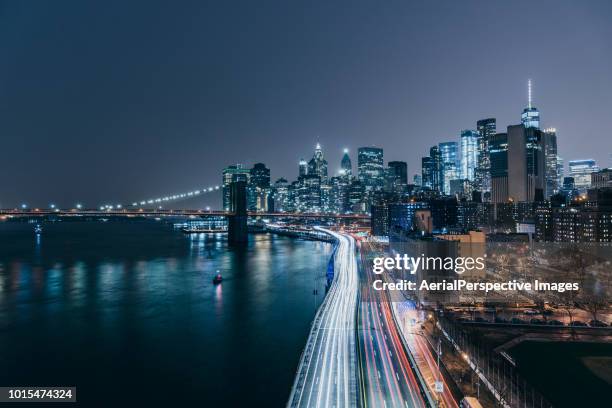 tail light of manhattan downtown at night - city lights reflected on buildings speed stock pictures, royalty-free photos & images