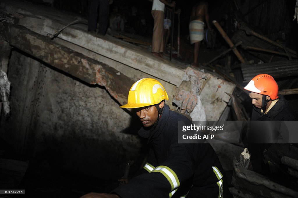 Bangladeshi firemen look for trapped sur