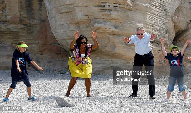 Junior rangers Paige Owens and Kayla Salehian, help first lady Michelle Obama and Sen. Harry Reid, at the Red Rock Canyon National Conservation Area...