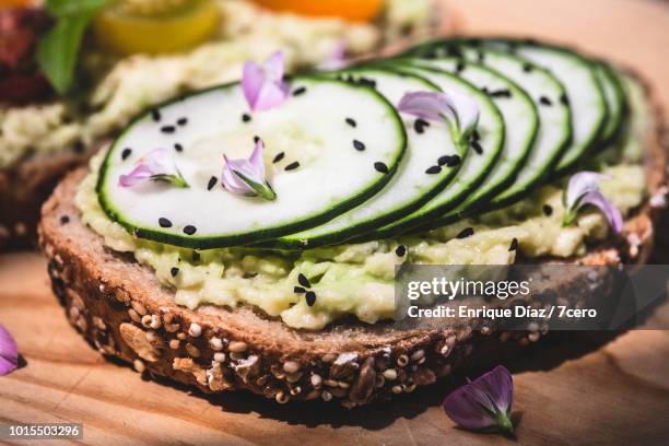 smashed avocado on toast with cucumber and flowers, close up - edible flower stock pictures, royalty-free photos & images
