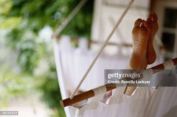 30s man relaxing in hammock, feet up - hammock fotografías e imágenes de stock