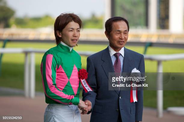 Jockey Masami Matsuoka and Yukio Okabe at the presentation ceremony of Race 12 Unicorn Stakes at Tokyo Racecourse on June 6 , 2010 in Tokyo, Japan.