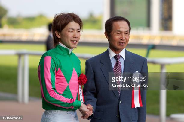 Jockey Masami Matsuoka and Yukio Okabe at the presentation ceremony of Race 12 Unicorn Stakes at Tokyo Racecourse on June 6 , 2010 in Tokyo, Japan.