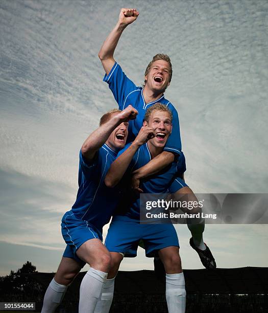 three soccer player celebrating - football player silhouette stock pictures, royalty-free photos & images