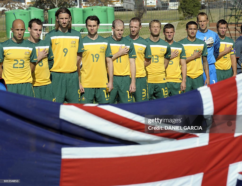 The Australian football team stands duri