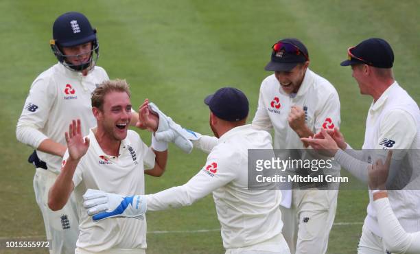 Stuart Broad of England celebrates taking the wicket of Dinesh Karthik of India during the day four of the Specsavers 2nd Test match between England...